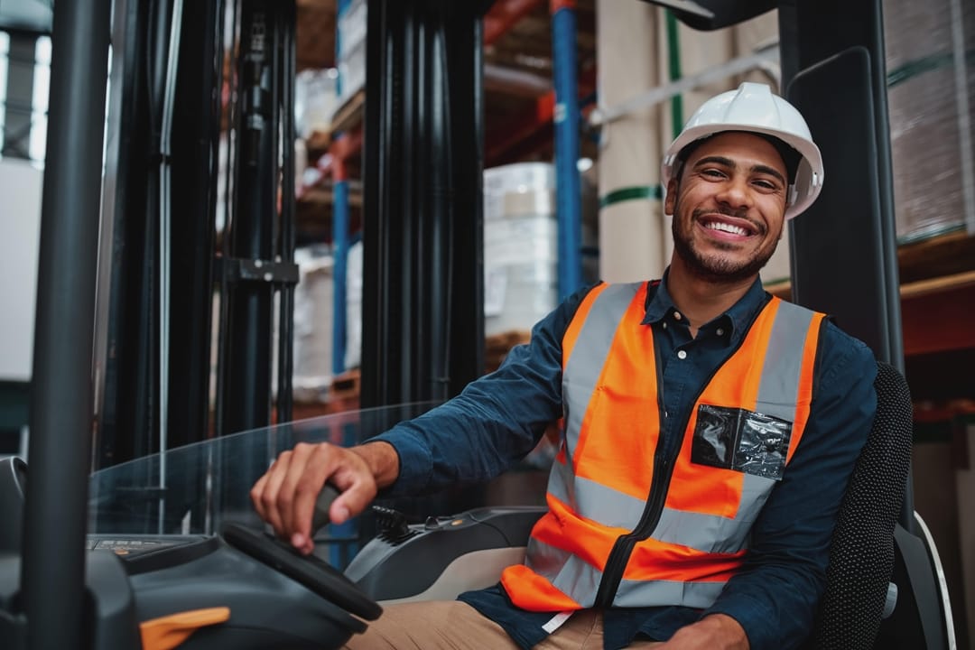 Worker sitting on forklift