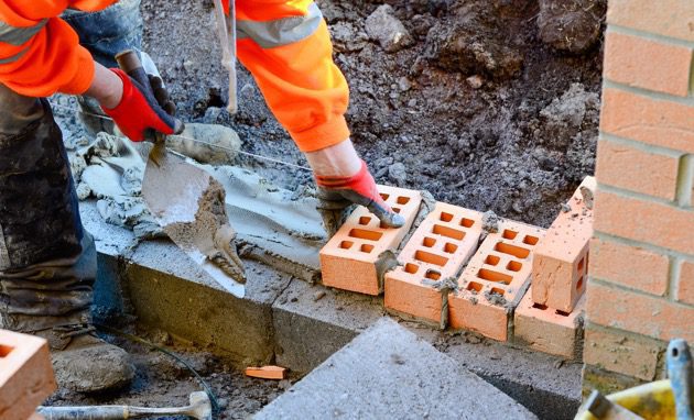 worker laying bricks